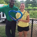 man and woman posing with heart balloon