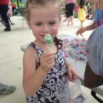 young girl holding lolipop