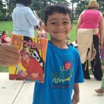 young boy holding pirate card